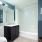 large mirror in bright bathroom with shower/tub combo
