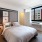 furnished bedroom with oversized windows