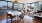 dining room open to living area surrounded by oversized windows