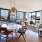 dining room open to living area surrounded by oversized windows