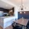 kitchen with serving counter next to lighted dining area